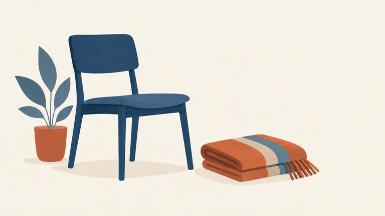 Illustration of an empty chair beside a folded blanket